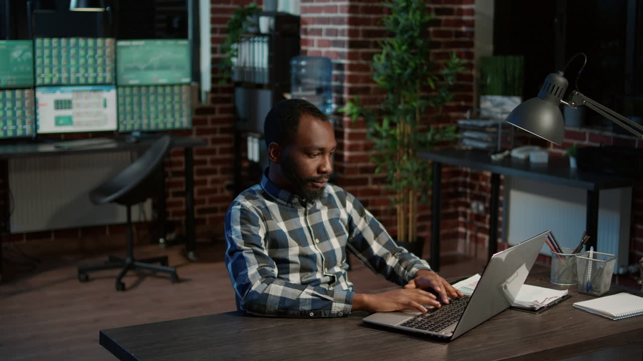 Portrait of african american broker working with stock market charts