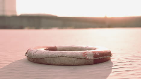 lifebuoy on the city beach at sunset