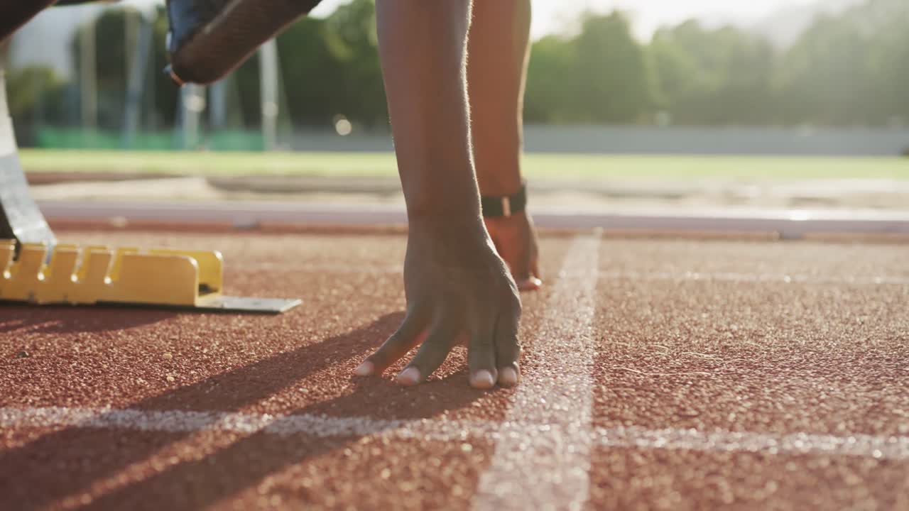 Disabled mixed race man with prosthetic legs starting a race