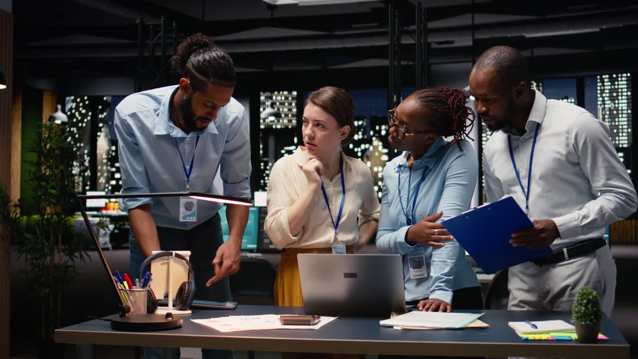 Diverse men and women working together on project in corporate space