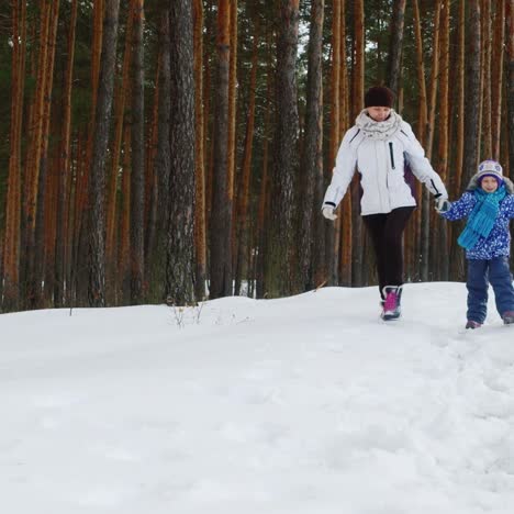 Mother-Walks-With-Her-Two-Children-In-Snow-02