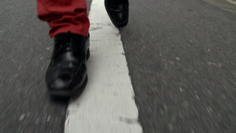 close-up of a man walking fast on the street