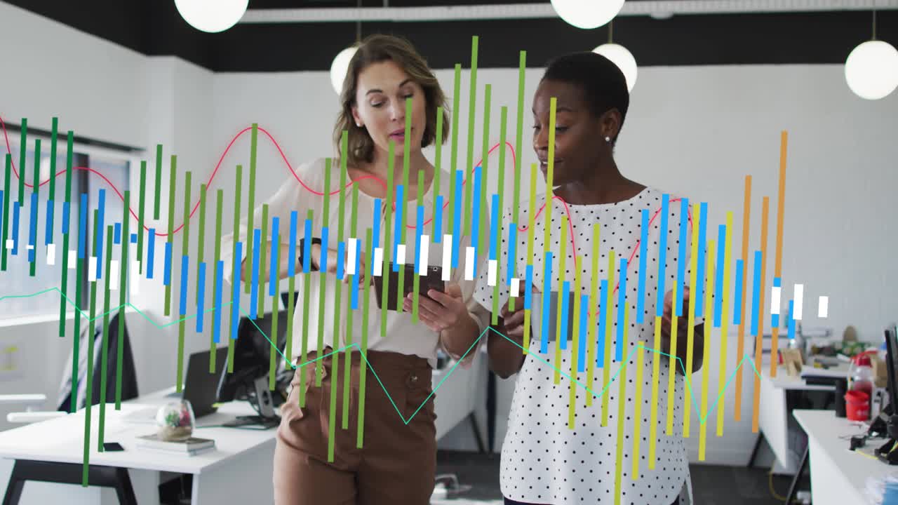 Two coworkers walking office tablet rotating showing data bars and waves reviewing business metrics