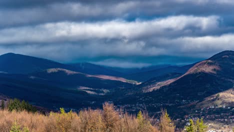 TimeLapse-Of-A-Mountain-Range-With-Thick-White-Clouds-Swirling,-Fall-Colors,-Romania