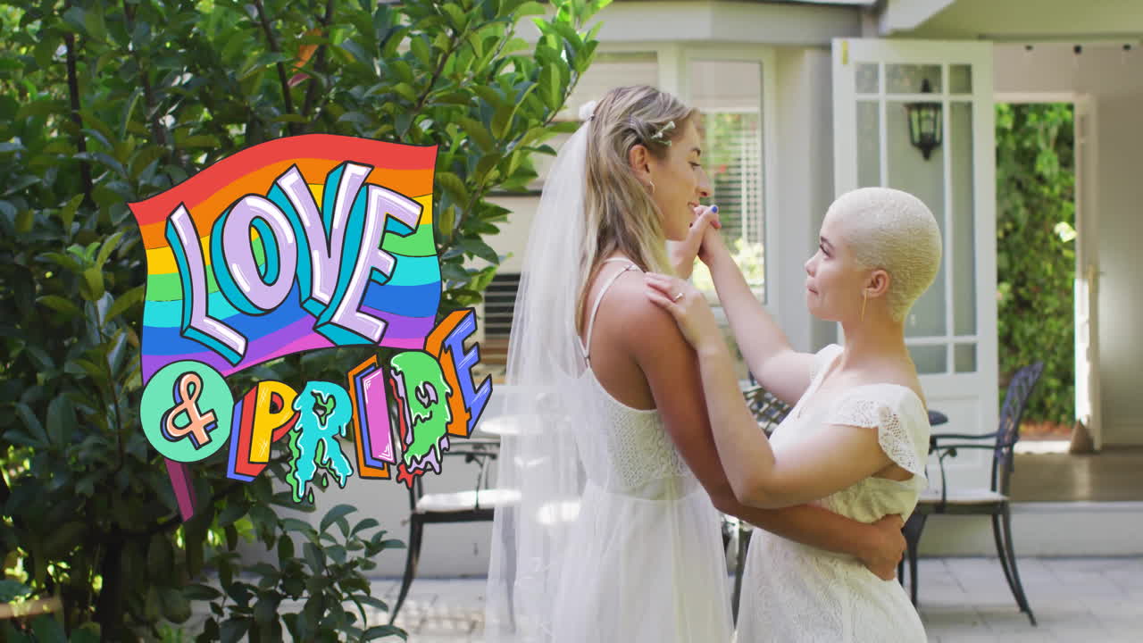 Animation of rainbow love and pride text over diverse female married couple dancing
