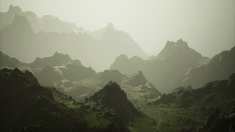 mountain landscape with misty peaks and lush valleys at dawn
