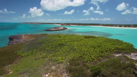 beautiful islet and turquoise ocean during summertime in bahamas - aerial drone shot