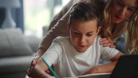 mom helping son doing homework