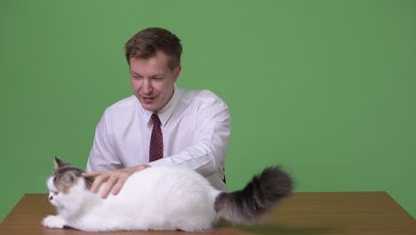 young handsome scandinavian businessman against green background