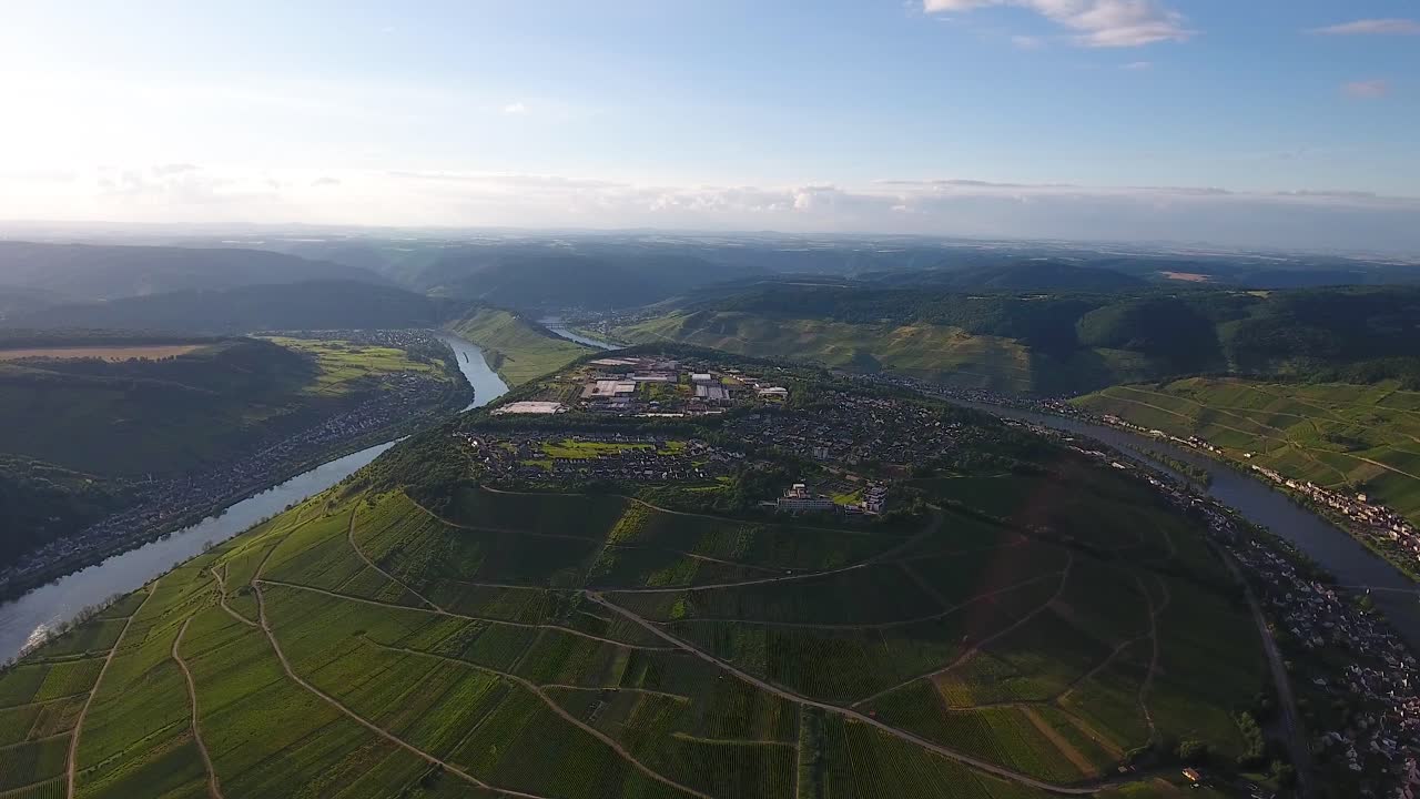 Drone aerial right rotatingview hill with village on top and a river bellow
