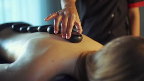 Image-of-a-woman-getting-massage-with-stones-on-her-back