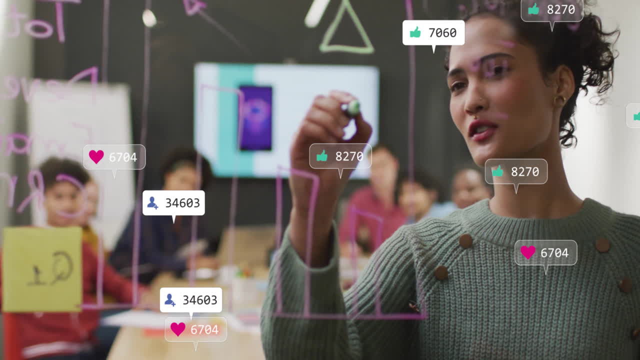 Animation of media icons over diverse business people discussing work