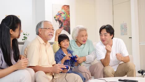 asian family enjoying a video game together in a bright living room, showcasing joy and connection across generations