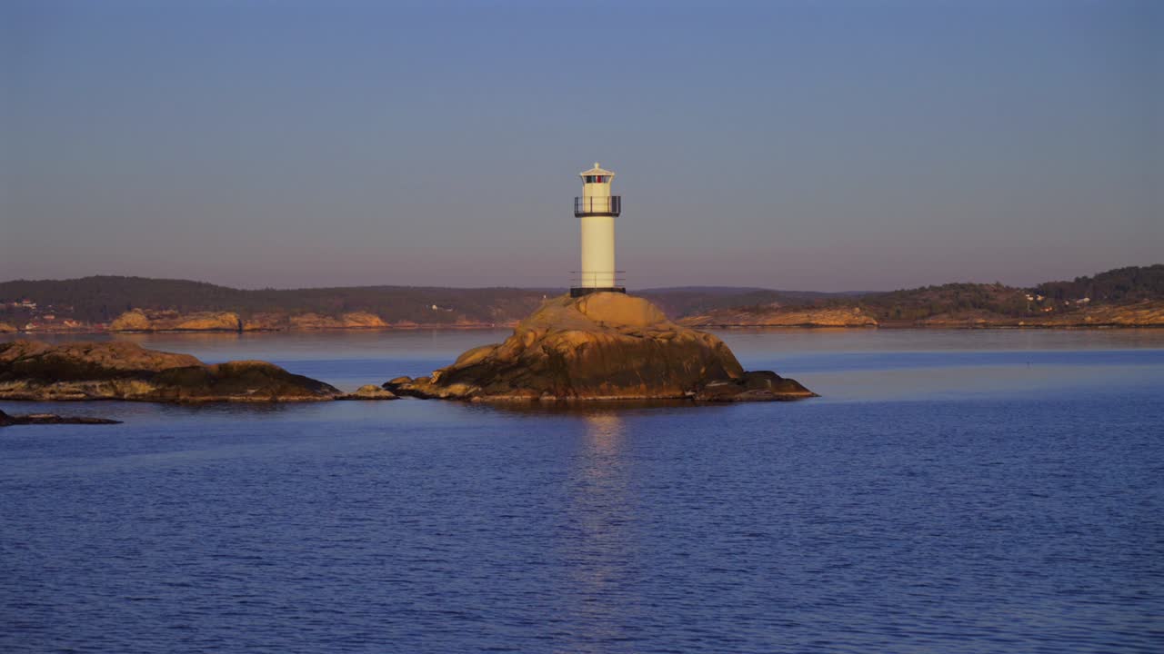 Lighthouse Strömstad Stromstad Fjord Ursholmen Sweden sea ferry boat ride land of the Svea Sverige calm sea ocean water late arctic afternoon sunset Nordkoster enchanting coastal beauty circle motion