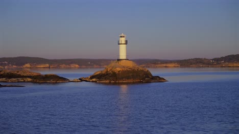 lighthouse strömstad stromstad fjord ursholmen sweden sea ferry boat ride land of the svea sverige calm sea ocean water late arctic afternoon sunset nordkoster enchanting coastal beauty circle motion