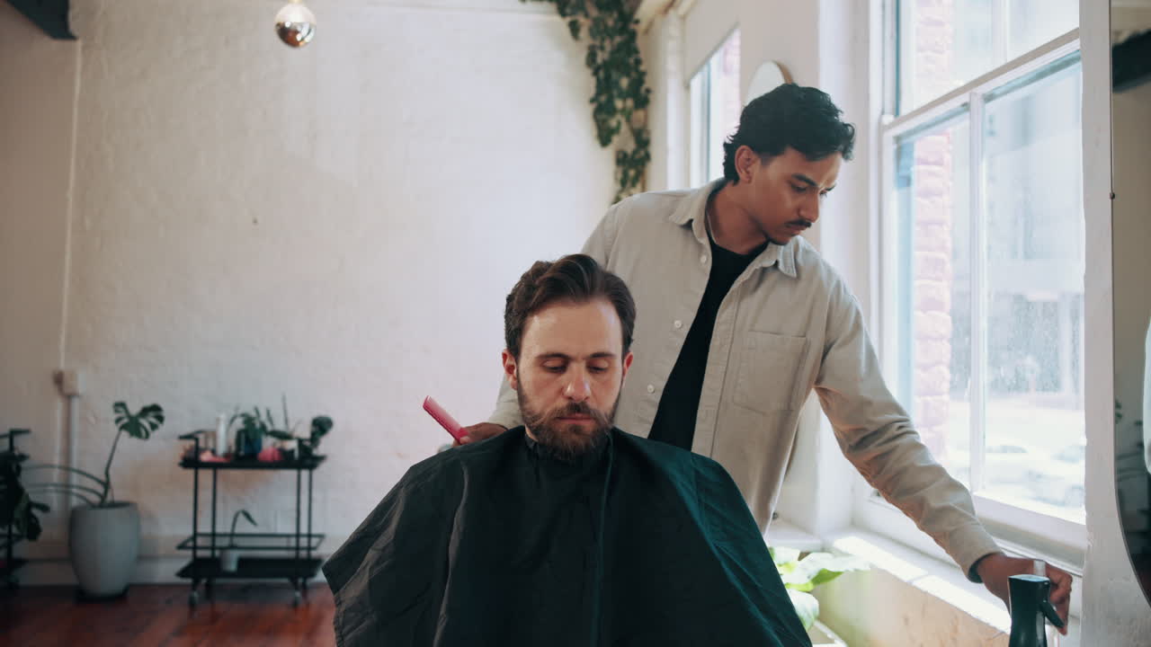 Barber Cutting a Man's Hair in a Modern Barbershop