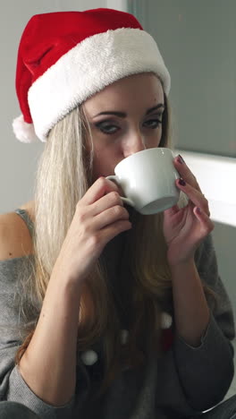 women with cup of tea. young women relaxing with cup of hot drink and warming up on the window sill vertical video