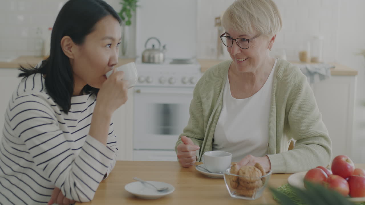 Daughter and Grandmother Enjoying Coffee Together