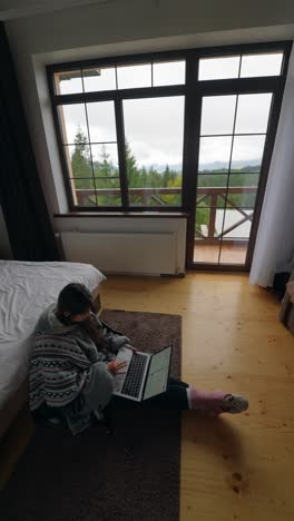 mujer trabajando desde casa con una hermosa vista de la montaña