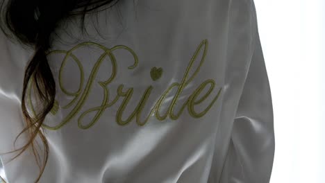 silk robe with 'bride' embroidered in gold on the back