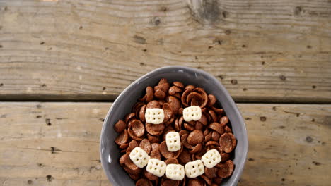 chocolate cornflakes with honeycomb cereal forming smiley face in bowl 4k