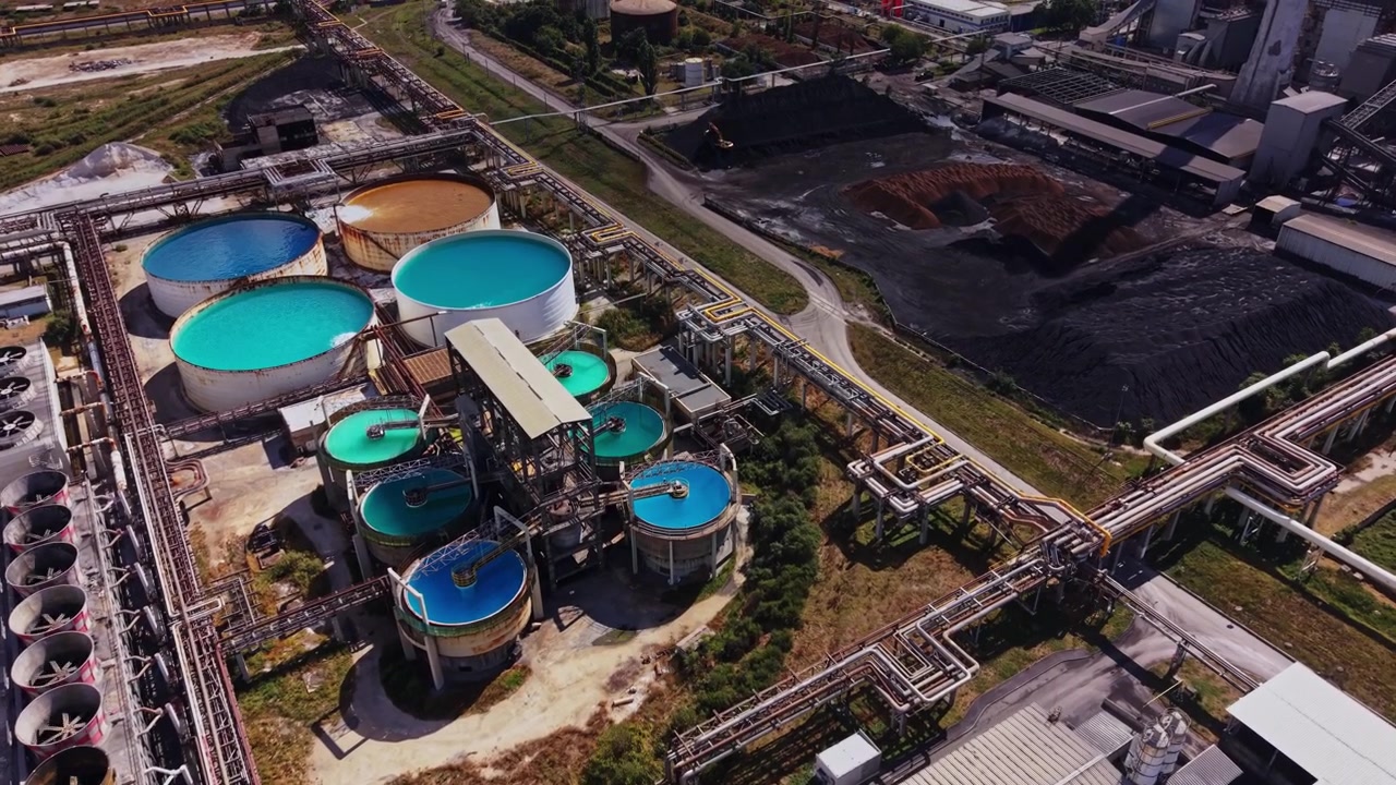 Large industrial site with water tanks and pipelines in operation