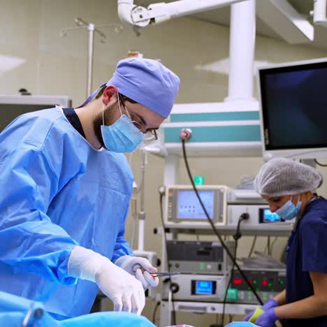 doctor and nurse in modern hospital. medical workers in protective uniform prepare surgical tools before the operation. modern operating room.
