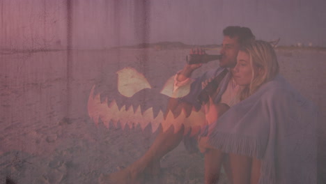 couple sitting on beach with drinks, abstract animation overlaying scene