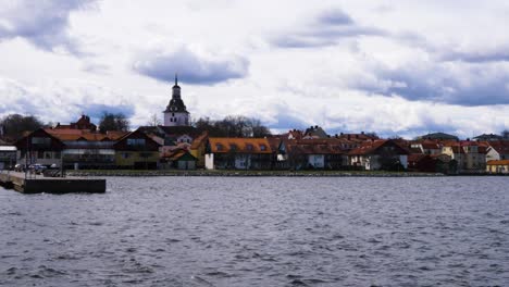 waterfront houses with tower of st