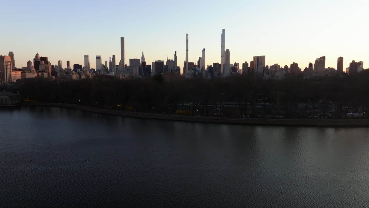 el embalse del parque central y los rascacielos de manhattan, el atardecer en nueva york, ee.uu. - descendiendo, disparo de avión no tripulado