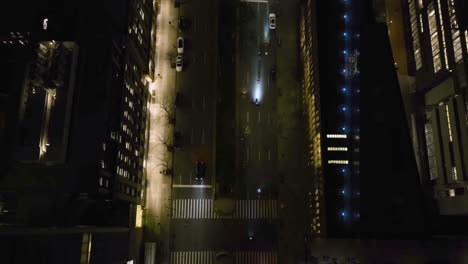 Aerial-view-following-motorcycles-on-the-night-lit-street-of-New-York,-USA