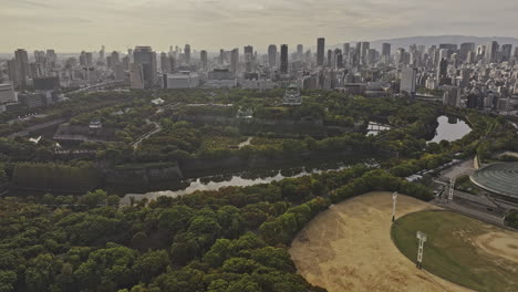 Osaka Japan Aerial v62 drone flyover Osakajo Park capturing historic Japanese landmark, imposing moats and towering castle keep against downtown cityscape - Shot with Mavic 3 Pro Cine - Oct 9th 2023