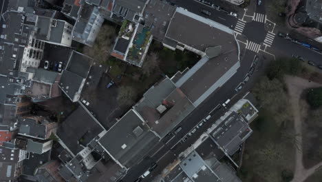 Birds-eye-shot-of-urban-borough.-Fly-above-city.-Cars-driving-on-streets-between-apartment-buildings.-Cologne,-Germany