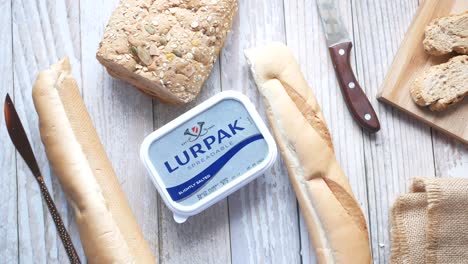 assorted breads and butter on wooden table