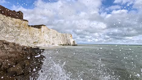 waves hitting cliffs and concrete blocks