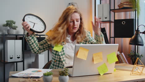 tired businesswoman using laptop sticky notes with many tasks overworked checking time on clock