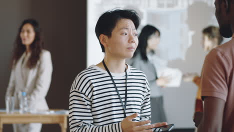 Asian-Woman-Having-Talk-with-Colleague-on-Business-Event