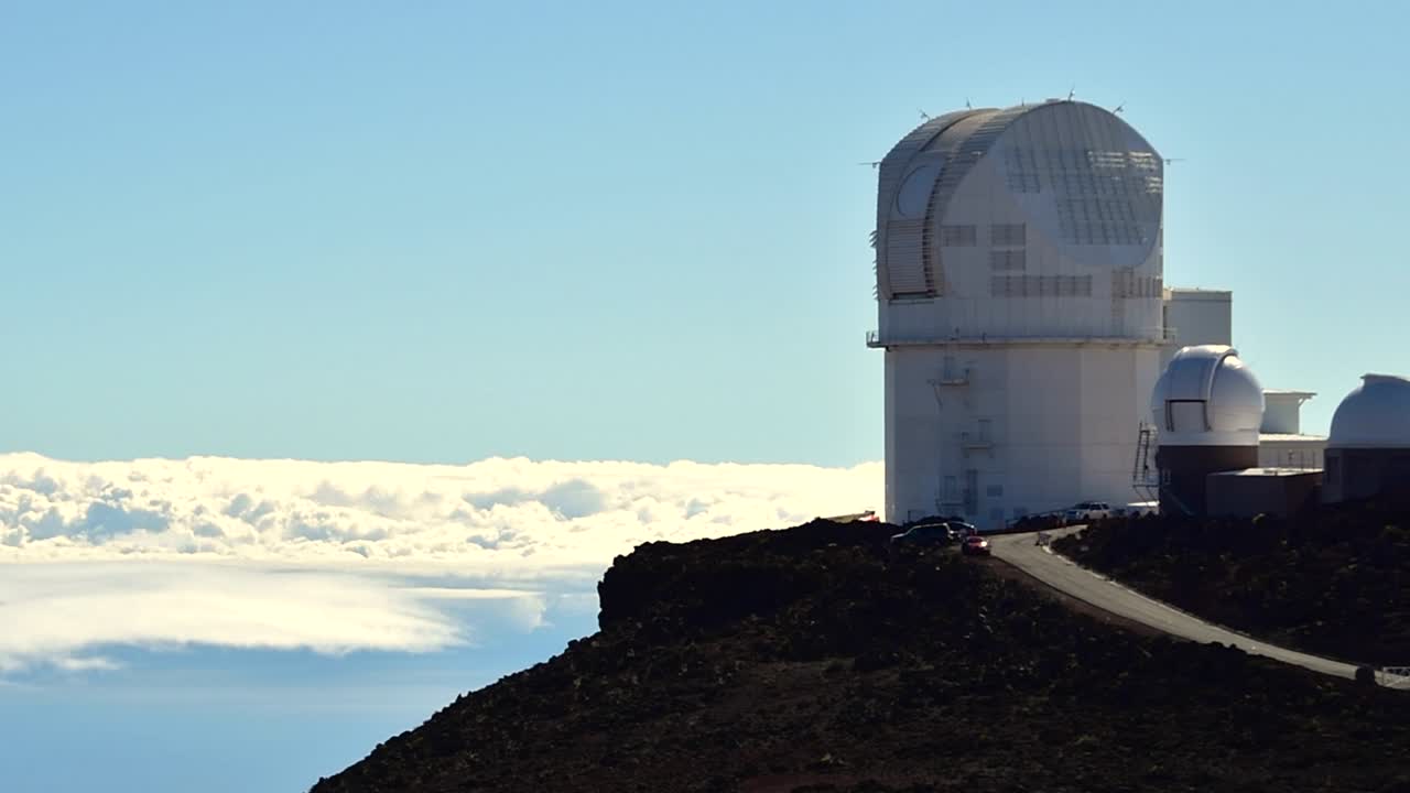 Pan Daniel K.Inouye Solar Telescope, DKIST  on Mount Haleakala summit to the cloud bank below, Maui, Hawaii