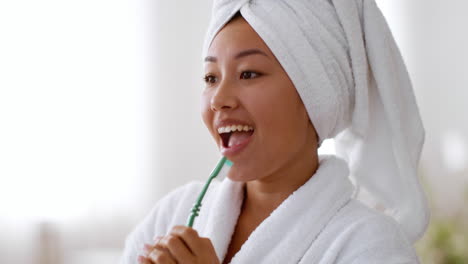 woman brushing her teeth in the bathroom