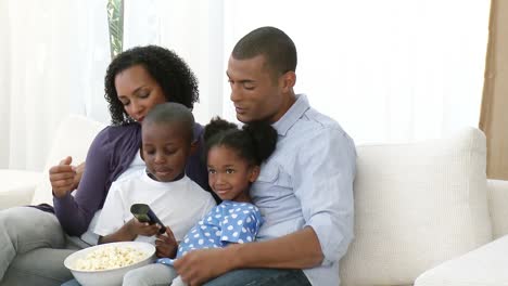 afroamerican parents and children watching television