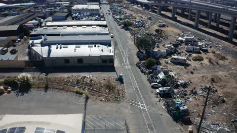 garbage in a homeless camp of ruined cars and dilapidated houses and rv's