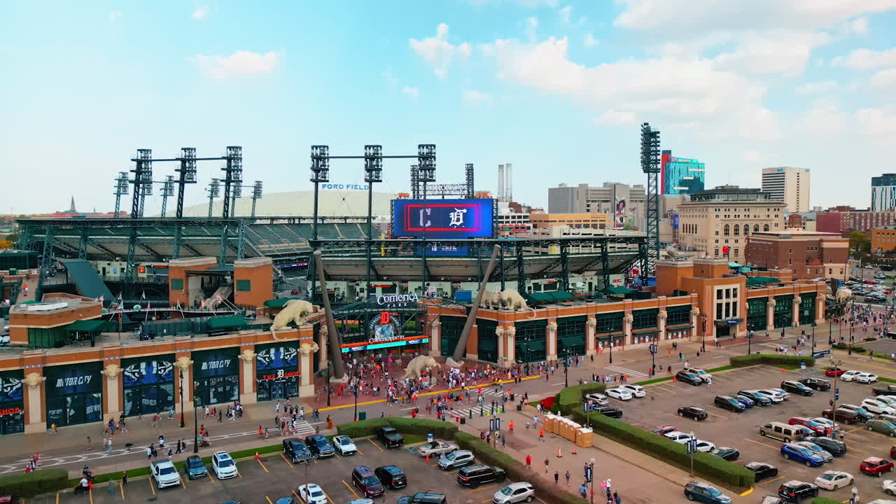 Detroit, USA, 28 July 2025: Busy parking lots in the front of the Comerica Stadium in Detroit, Michigan, USA. Lots of people are near the entrance to the stadium. Aerial perspective