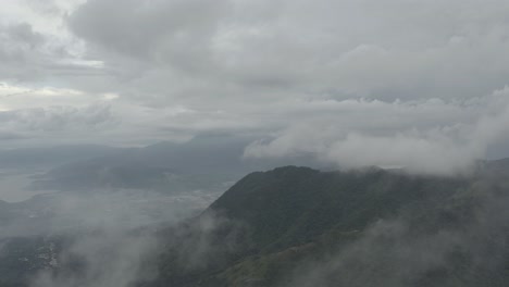 Drone-aerial-rising-flying-through-clouds-over-the-mountains