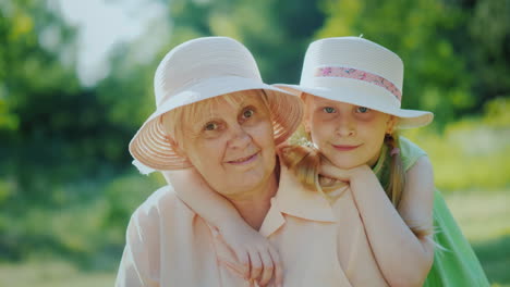 portrait of a happy elderly woman with her granddaughter smiling looking at the camera 4k video