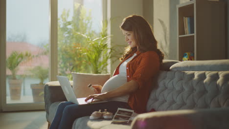 pregnant woman shopping online for baby items