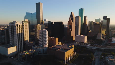 aerial view around the sunlit skyline of houston, dramatic sunset in texas, usa