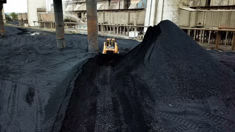 crawler bulldozer sorts coal. industry. aerial view.