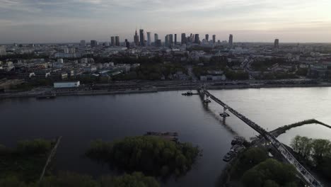 Aerial-dolley-view-of-tourism-walking-over-the-new-Agrafka-bridge-in-Warsaw-after-sunset