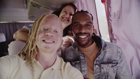 diverse friends taking a joyful selfie inside a bus