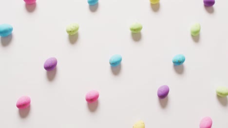 close up of multiple colorful easter eggs on white background